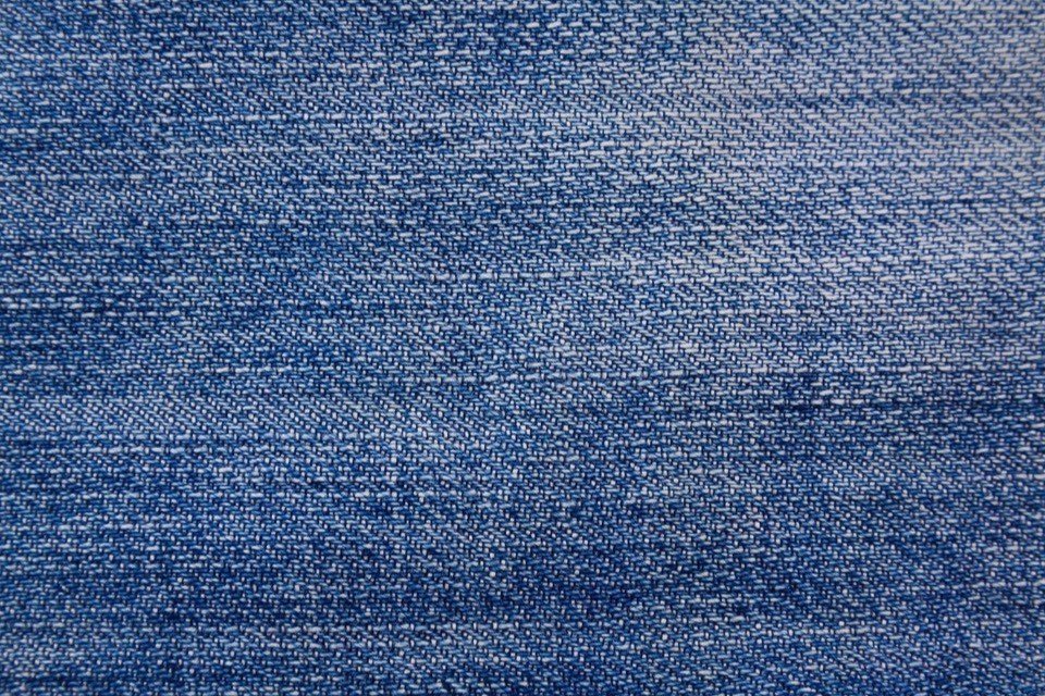 Gros plan d’un tissu : trame et chaîne visibles.